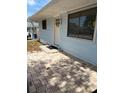 Light blue home with brick patio in front and window near door at 1408 San Juan Ct, Clearwater, FL 33756