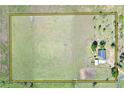 Aerial view of the property, surrounded by expansive land, showcasing its potential for outdoor activities and privacy at 14655 Joe Sumner Rd, Wimauma, FL 33598