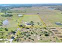 Expansive property with a charming home nestled within a picturesque, open landscape with a pond at 14655 Joe Sumner Rd, Wimauma, FL 33598