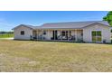 Charming exterior of a ranch-style home featuring a covered porch, perfect for relaxing and enjoying the outdoors at 14655 Joe Sumner Rd, Wimauma, FL 33598