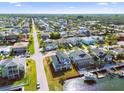 Aerial view of waterfront home with adjacent canal access and neighborhood setting at 15621 Bertram Dr, Hudson, FL 34667
