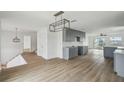 Renovated kitchen features modern gray cabinets, new hardwood floors, and recessed lighting at 15621 Bertram Dr, Hudson, FL 34667