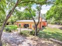 Expansive backyard with a patio, new sod, mature trees, and a fenced-in yard at 18826 Huckavalle Rd, Odessa, FL 33556