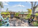 Back deck with comfortable seating, potted plants, and a fenced yard at 201 11Th S Ave, Safety Harbor, FL 34695