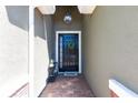 Close-up of a front door with wreath and overhead lighting, creating a warm entrance at 2855 Oriole Dr, Sarasota, FL 34243