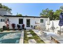 Inviting backyard with pool, patio with dining table, and stylish landscaping at 3131 W Fielder St, Tampa, FL 33611