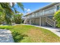 Expansive backyard featuring lush green grass, tropical landscaping, and a view of the inviting pool at 3901 Pompano Se Dr, St Petersburg, FL 33705