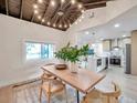 Stunning dining room with vaulted ceiling and decorative chandelier and adjacent kitchen at 400 38Th Ne Ave, St Petersburg, FL 33703