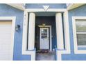 This beautiful entryway has white pillars, a storm door and modern house numbers at 4610 Courtland St, Tampa, FL 33610