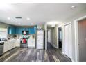 Spacious kitchen with stainless steel appliances, blue and white cabinets, and modern gray flooring at 4610 Courtland St, Tampa, FL 33610