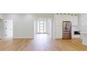 Open-concept living area with hardwood floors, white walls, and modern kitchen features at 5051 Gevalia Dr, Brooksville, FL 34604