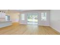 Bright, airy living room with hardwood floors and sliding glass doors to the outdoors at 5051 Gevalia Dr, Brooksville, FL 34604