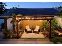 Cozy backyard with stone patio, pergola, and lush plants creating a serene retreat at 5201 18Th S Ave, Gulfport, FL 33707