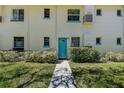Charming exterior of building with a teal door, and professionally landscaped surroundings at 525 9Th N Ave # 2, St Petersburg, FL 33701