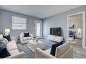Bright living room with a glass coffee table, plush seating, and light gray wood flooring at 525 9Th N Ave # 2, St Petersburg, FL 33701