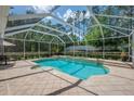 Screened-in pool area with water features and a spacious patio for entertaining and relaxation at 5913 Flatwoods Manor Cir, Lithia, FL 33547