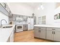 Bright kitchen featuring gray cabinets, white countertops, and stainless steel appliances at 6208 Country Club Way, Sarasota, FL 34243