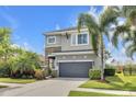 Charming two-story home with stone accents, a well-maintained lawn, and a convenient two-car garage at 6518 Salt Creek Ave, Apollo Beach, FL 33572