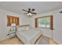 Bright bedroom featuring natural light, hardwood floors, ceiling fan, and neutral paint at 7491 Cedar Ne St, St Petersburg, FL 33702