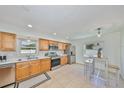 Updated kitchen featuring stainless steel appliances, wooden cabinets, tile flooring and eat-in breakfast nook at 7491 Cedar Ne St, St Petersburg, FL 33702