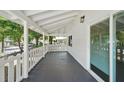 Inviting covered porch with white columns and railing, offering a peaceful outdoor space at 8215 N 12Th St, Tampa, FL 33604