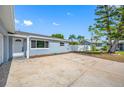 Side view of a cozy home with a spacious driveway and manicured landscaping at 8409 Lantana Dr, Seminole, FL 33777