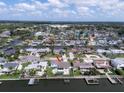 Canal front home with a swimming pool, private dock, and lush landscaping at 8722 Hickorywood Ln, Tampa, FL 33615