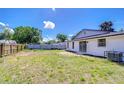 Backyard with new fence and large grass area at 911 Kirkcaldy Way, Valrico, FL 33594