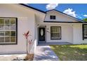 Well maintained single Gathering home with black door and trim, and green lawn at 911 Kirkcaldy Way, Valrico, FL 33594