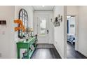 Welcoming foyer with dark wood floors, decorative console table, mirror and stylish decor at 11422 Calusa Trails Way, Riverview, FL 33569