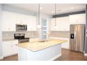 Spacious gourmet kitchen with granite countertops and stainless steel appliances at 17833 Althea Blue Pl, Lutz, FL 33558
