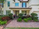 Inviting front entrance with brick walkway, well-maintained landscaping, and covered entry at 1804 Bella Casa Ct, Tampa, FL 33618