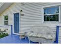 This home features a relaxing, blue porch seating area, perfect for enjoying quiet moments at 1920 30Th E Ave, Bradenton, FL 34208