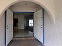 Open entryway featuring a tiled floor and arched doorway leading into the home's interior at 23059 Geneva Rd, Land O Lakes, FL 34639