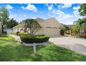 Well-maintained home with a long driveway, three-car garage, and neatly trimmed hedges at 2605 Durant Trails Blvd, Dover, FL 33527