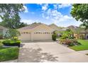 Attractive single-Gathering home with a neatly manicured lawn, three-car garage, and serene surroundings at 2605 Durant Trails Blvd, Dover, FL 33527