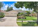 Inviting home with a three-car garage, well-maintained landscaping, and a spacious driveway at 2605 Durant Trails Blvd, Dover, FL 33527