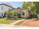 Inviting home featuring a well-maintained lawn, mature landscaping, and a brick driveway leading to the residence at 300 16Th N Ave, St Petersburg, FL 33704