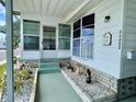 Charming entrance with decorative landscaping, covered porch and a 