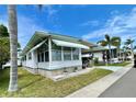 Attractive single-story home with awning, carport and well maintained landscaping, in a tropical setting at 34222 Canal N Dr, Pinellas Park, FL 33781