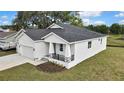 Attractive home showcasing an attached garage and landscaped front yard at 38151 Sunset Ave, Dade City, FL 33525