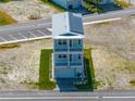 Aerial view of a charming home with manicured lawn and stone driveway, showcasing the roof and street access at 4215 Saltwater Pearl Way, Cortez, FL 34215