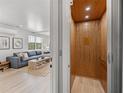 Modern home featuring an elevator for easy access between floors, adjacent to a stylish living room at 4215 Saltwater Pearl Way, Cortez, FL 34215