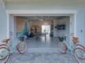 Spacious garage featuring ample storage, a sauna, ping pong table, bikes and surfboards for an active lifestyle at 4215 Saltwater Pearl Way, Cortez, FL 34215