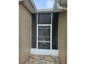 Close-up of a screened-in front entryway with a decorative security door at 607 Manchester Woods Dr # 84, Sun City Center, FL 33573
