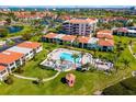 Beautiful aerial view of a condo community with pool, lush landscaping, and tropical feel at 6357 Bahia Del Mar Blvd # 403, St Petersburg, FL 33715