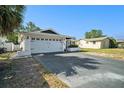 View of a house displaying a two-car garage with a spacious driveway and a well-maintained front exterior at 7136 Isle Dr, Port Richey, FL 34668