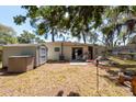 Spacious backyard with a small storage shed, and patio area for outdoor relaxation at 7339 Royal Palm Dr, New Port Richey, FL 34652