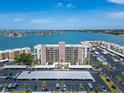 Aerial view of the condo building, covered parking area, and ocean views at 7700 Sun Island S Dr # 107, South Pasadena, FL 33707