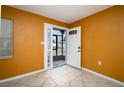 Bright foyer featuring tile floors, glass block window, and unique paint colors at 9130 Dresden Ln, Port Richey, FL 34668